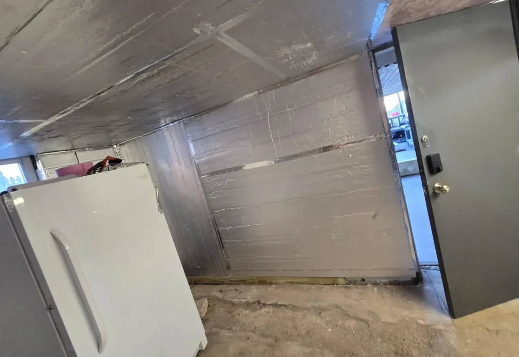 Home insulation being installed in attic to improve summer energy efficiency